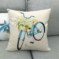 Close-up of linen pillowcase with blue vintage bicycle and daisy flower design on gray sofa - Bright Blue Bicycle with Daisies (Style 2)
