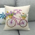 Detail of linen pillowcase with purple watercolor bike and flowers on a sofa - Purple Bicycle with Flower Basket (Style 3)