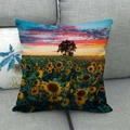 Close-up of linen cushion cover showing sunflower field sunset print on gray sofa - 45x45cm / Sunflower Sunset Glow (13)