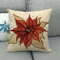 Detail view of linen Christmas pillowcase with artistic poinsettia floral print on sofa - Ink Splatter Floral Style (8)