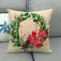 Funda de cojín de lino navideño con corona floral y flores de pascua en sofá gris - Estilo de Corona de Navidad Clásica con Piñas (1)