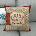 Detail of Joy to the World Christmas linen pillowcase on a grey sofa with snowflake patterns - Red Joy To The World (2)