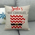 Detail of linen Christmas pillowcase showing Santa's hot chocolate print on couch - Beige Santa Hot Chocolate (4)