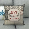 Close-up of linen Christmas pillow case with JOY to the world print on a sofa - Beige Collage Joy To The World (10)