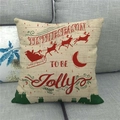 Detail of Christmas linen pillowcase with Santa sleigh design on a grey fabric sofa - Santa Sled Cityscape (11)
