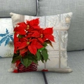 Detail of linen Christmas pillowcase with red poinsettia oil painting on grey sofa - 45x45cm / Window Poinsettia Pot (13)