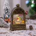 Close-up of vintage bronze snow globe lantern with snowman and golden reindeer scenery - Rotating-Snowman