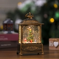 Primo piano della lanterna natalizia vintage in bronzo con Babbo Natale e glitter - Babbo Natale con sacchetti regalo