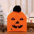 Detail of LED Halloween pumpkin beanie showing the plush pompom and manual power switch - Ghost Face