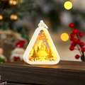 Close-up of LED Christmas lantern with warm glow and Merry Christmas gold tree design - White Tree