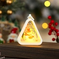 Detail of a glowing Christmas lantern with snowman silhouettes and warm LED light effect - White Snowman
