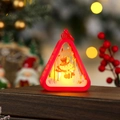 Detail of red Christmas lantern with warm LED light featuring a snowman and tree silhouette - Red Snowman
