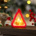 Close-up of red Christmas lantern with Santa pattern and warm LED glowing bokeh - Red Reindeer Sleigh