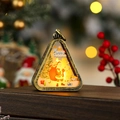 Detail of vintage Christmas lantern featuring Santa pattern and warm LED glow decor - Brush Gold Santa with Bag