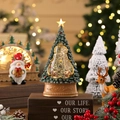 Close-up of lighted Christmas tree snow globe with music and micro landscape on wood - Tree House