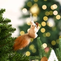 Close-up of a Christmas squirrel ornament with fur tail and pine cone on a pine tree - Squirrel Pendant Type A / 14x4x7cm