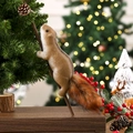 Detail of a fluffy faux fur squirrel ornament hanging on a glowing Christmas tree branch - Climbing Squirrel Stick Large / 43x8.5x9.5cm