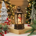 Close-up of a bronze Christmas lantern with a snowman and swirling glitter effect - Snowman (Rotating)