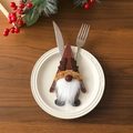 Close-up of gnome silverware holder with reindeer antlers on a white plate - Reindeer Style