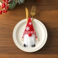 Close-up of a Christmas gnome cutlery holder with white snowflake embroidery on red felt - Snowflake Style