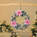 Detail of Christmas wreath with pink poinsettia and golden Merry Christmas sign - Pink Flower Style