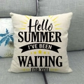 Linen summer cushion cover with Hello Summer text and sun motif on a gray sofa - Summer Sunshine Black and Yellow Style (13)