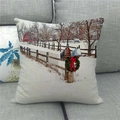 Detail of linen Christmas pillowcase showing winter snow scene on a gray sofa - Winter Country Red Farmhouse Style (10)
