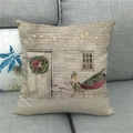 Detail of Christmas pillow cover with snowy house and red sleigh on a grey sofa - Vintage Country Red Sled Style (12)