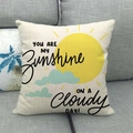 Linen pillow cover featuring yellow sun and You Are My Sunshine quote on gray sofa - Sun and Cloud Quote Style (5)