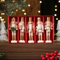 Close-up of five white and gold wooden nutcracker ornaments in a red gift box - White Nutcracker 5-Piece Set