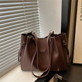 Minimalist large brown PU leather tote bag with shoulder straps in natural light setting - Coffee