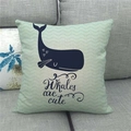 Detail of mint green linen pillowcase featuring a cute whale illustration on a grey sofa - Whale Wave Pattern Style Two (11)