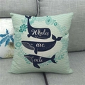 Detail of linen pillowcase with blue whale print and botanical patterns on gray sofa - Whale Wave Pattern Style Three (12)
