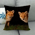 Detailed close-up of a lifelike fox print on a square linen cushion against a sofa - Red Foxes In Grass (14) / 45x45cm