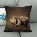 Linen pillowcase detail showing rhinos and birds in a wildlife landscape print on a grey sofa - Rhino Grassland Photography (8) / 45x45cm
