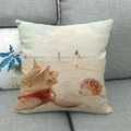 Linen pillow cover featuring a seashell and summer beach scene on a grey fabric sofa - 18x18 Inch / Digital Print Shell Seascape Style (15)