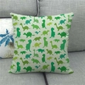 Detailed texture of beige linen pillowcase with green dinosaur silhouette patterns on sofa - 45x45cm / Beige Green Dinosaur Silhouette