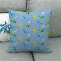 Detailed close-up of cartoon dinosaur linen pillow cover on a gray sofa - 45x45cm / Light Blue Cartoon Space Dinosaur
