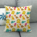Close-up of a linen cushion cover featuring colorful cartoon dinosaur prints on a sofa - 45x45cm / Colorful Cartoon Dinosaur Egg