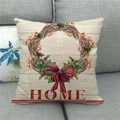 Close-up of linen cushion cover with Welcome Home wreath and red bow on sofa - HOME Red Bow Vine Wreath