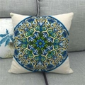 Close-up of bohemian mandala pattern on linen pillow cover against a grey sofa - Blue Yellow Bohemian Mandala Style