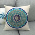Detailed close-up of bohemian mandala pattern on linen pillowcase over gray sofa - Turquoise Blue Mandala Style