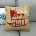 Detail of linen pillowcase featuring a red rocking chair and HOME text on grey sofa - HOME Red Rocking Chair Vintage