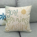 Linen cushion cover with Good Morning Sunshine print and sun graphic on sofa - Good Morning Sunshine Teal Style (12)