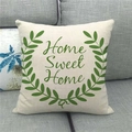 Close-up of linen pillow cover with Home Sweet Home text and olive wreath on a sofa - 18x18 Inch / Home Sweet Home Olive Branch Style