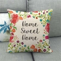 Close-up of Home Sweet Home linen pillowcase with colorful floral pattern on a grey sofa - 18x18 Inch / Home Sweet Home Country Floral Border Style