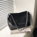 Minimalist black glossy shoulder bag with silver chain strap and pleated texture design - Black