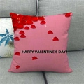 Close-up of Happy Valentine's Day linen pillow cover with rose petals on a sofa - Pink Base Rose Petals Greeting (1)