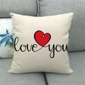 Close-up of linen pillowcase with red heart and 'love you' text on a gray sofa - 45x45cm / Handwritten love you Style