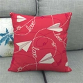 Detail of red linen pillowcase with paper plane and love text on grey sofa - Red Paper Plane Love (16)